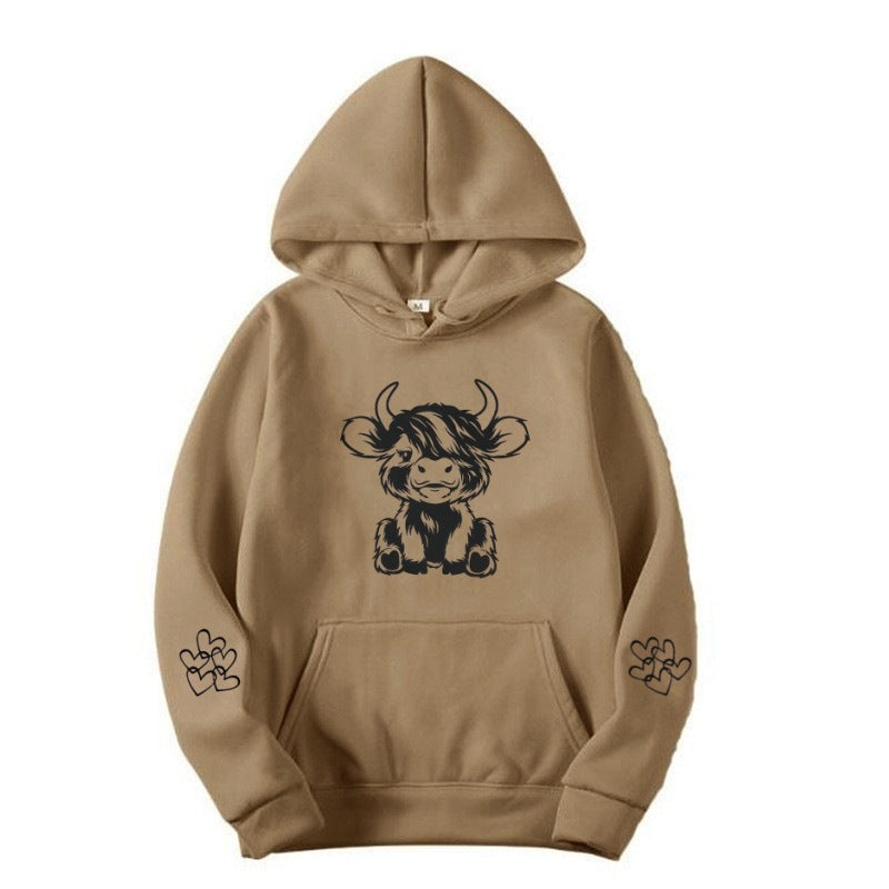 Women's hooded sweatshirt with charming cow motif and practical kangaroo pockets Lune London