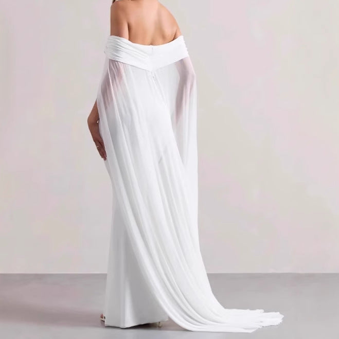 Elegant evening dress for women with off-the-shoulder design, flowing sheer cape, and flattering cut Lune London