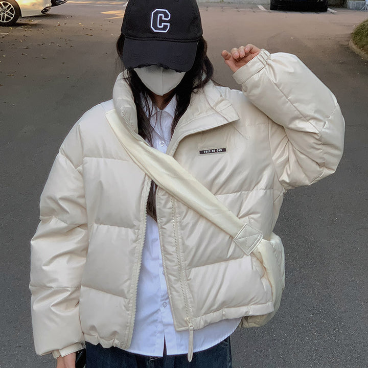 Trendy winter jacket for women with a high collar and zippered side pockets.