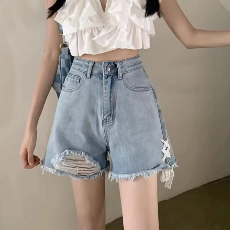 Ladies' denim shorts with trendy destroyed details and handcrafted accents