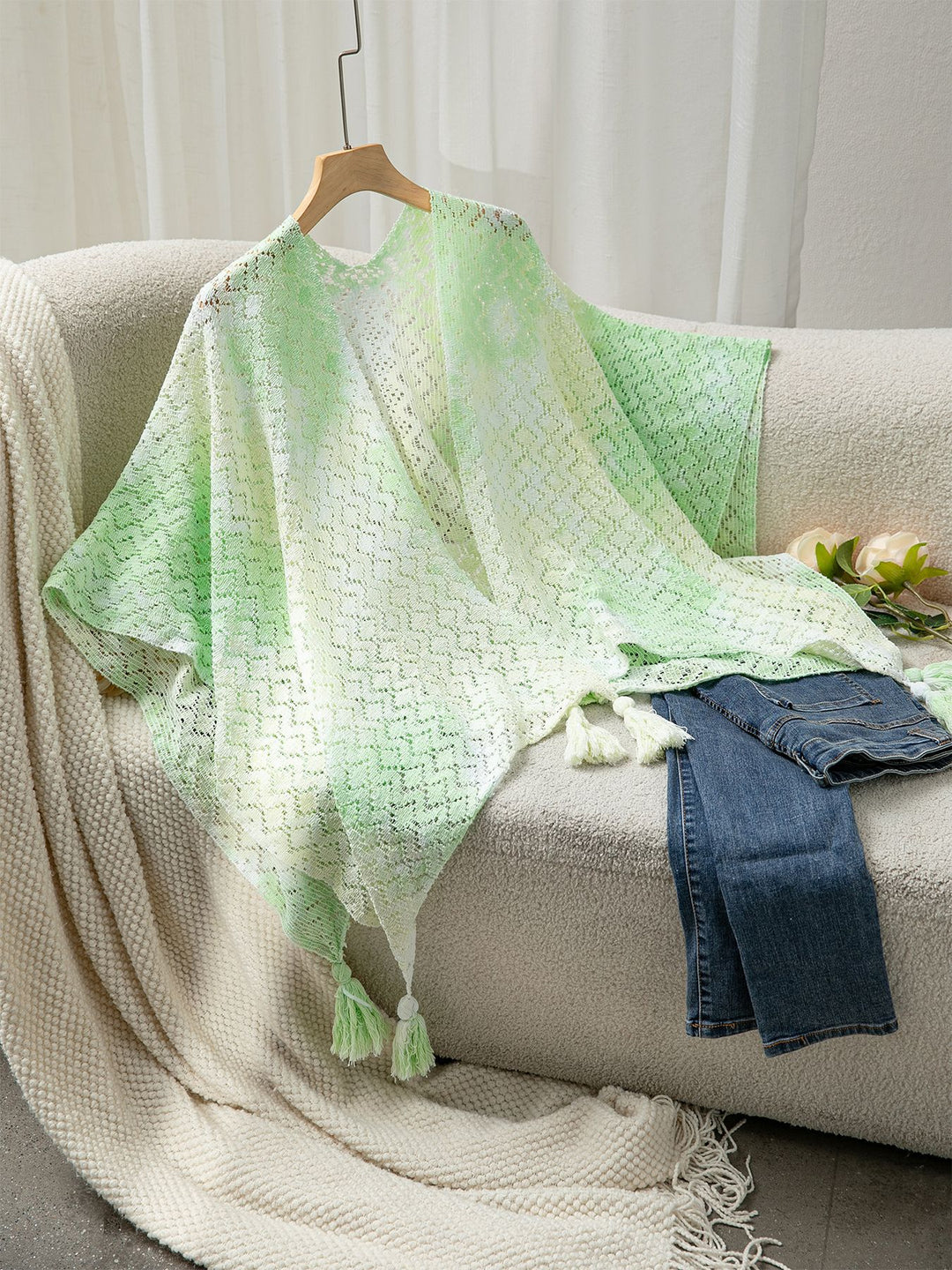 Airy knitted poncho for ladies with decorative fringes Lune London