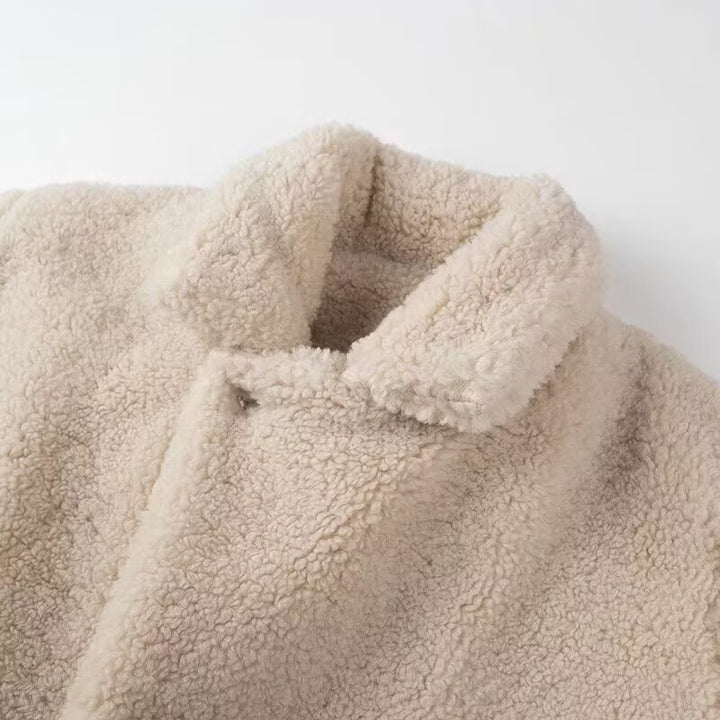 Fluffy teddy coat for women with elegant lapels and practical piped pockets Lune London
