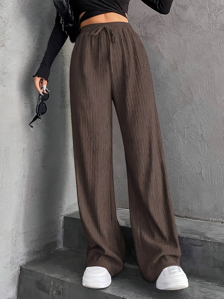 Pantalons plissés à coupe large pour femmes avec taille élastique et poches latérales pratiques Chic & Stil