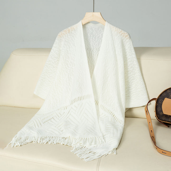 Elegant knitted poncho for women with fringe details and a distinctive pattern Lune London