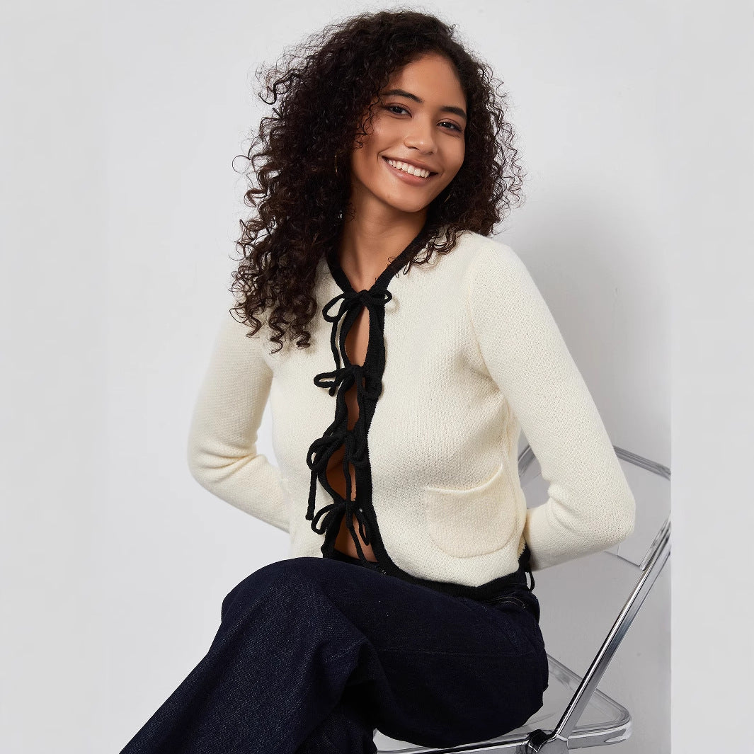 Fashionable women's knitted jacket with decorative belt and practical pockets Lune London