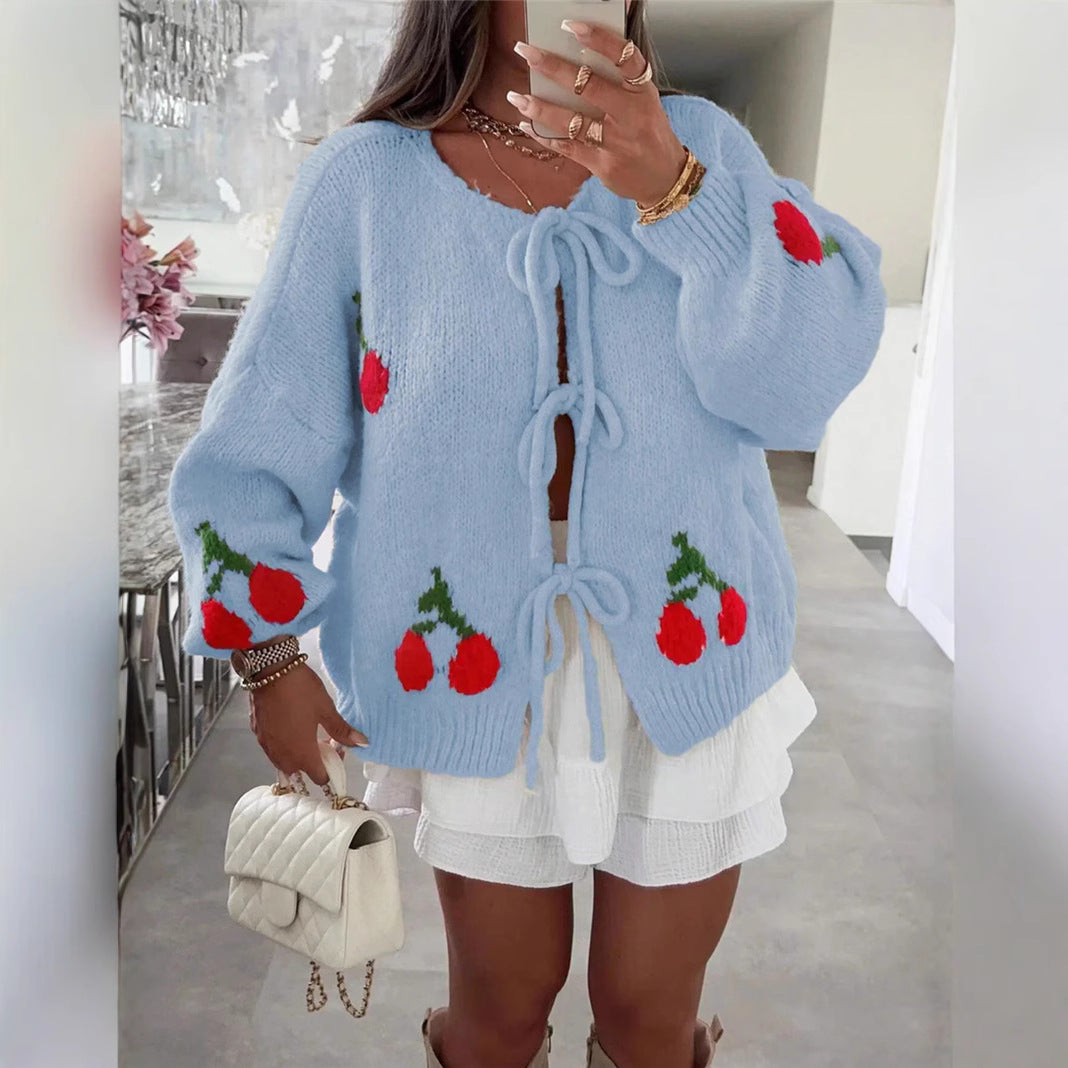 Women's knitted jacket with playful cherry pattern and decorative bows Lune London