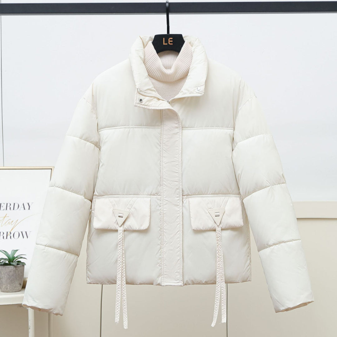 Quilted transitional jacket for women with high collar and practical modern pockets Lune London