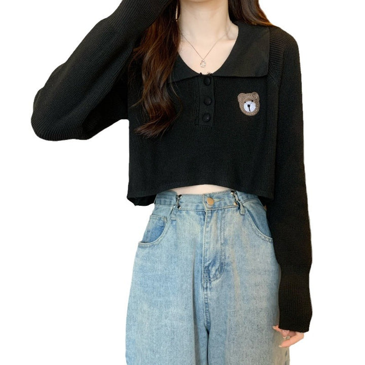 Women Cropped Pullover with a one-button closure and unicorn emblem