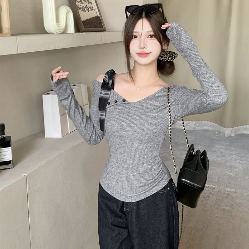 Women’s long sleeve top with modern asymmetric neckline and decorative button details Chic & Stil