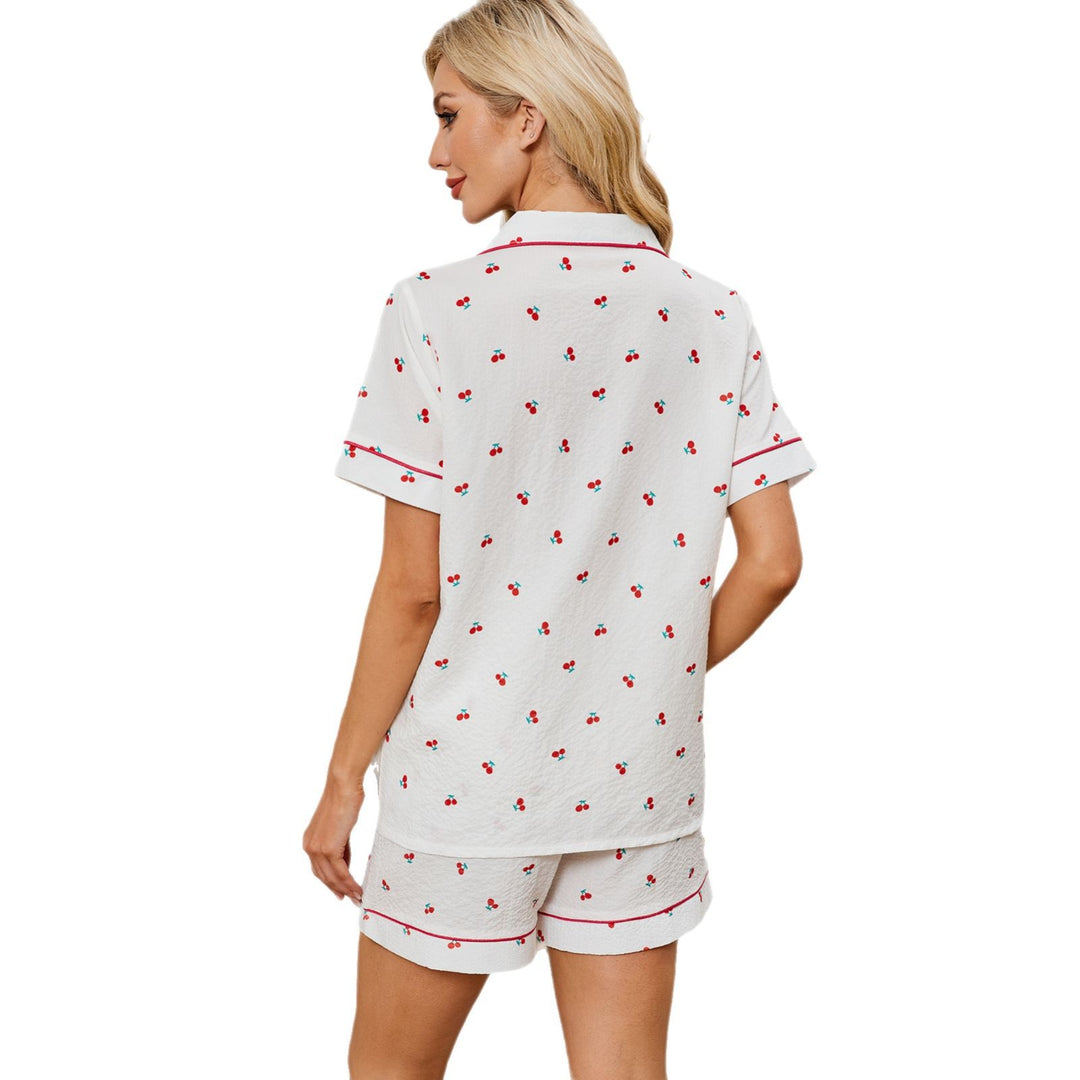 Women's pajama set with a cheerful cherry pattern and contrasting piping Lune London