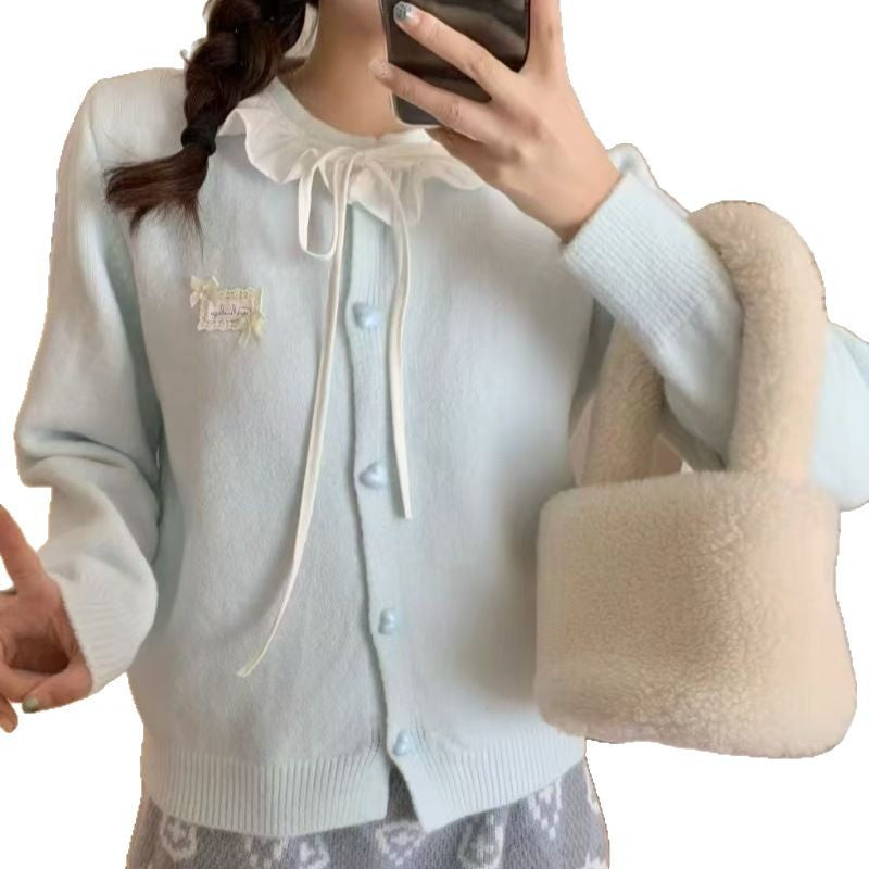 Ladies playful cardigan with ruffle detail and pearl-like buttons Lune London