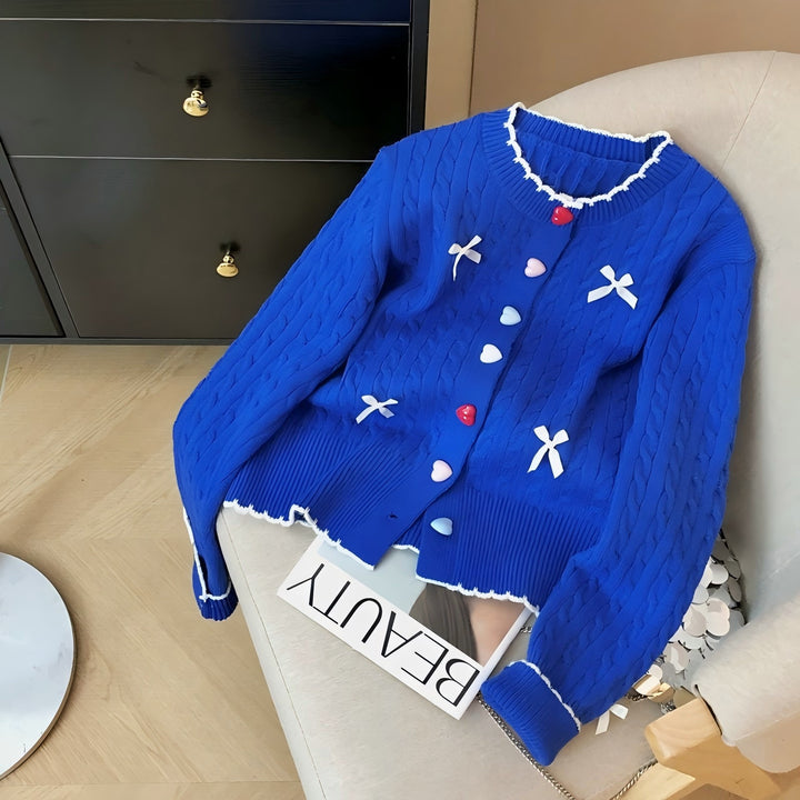 Knitted jacket for women with a playful cable pattern and colorful button details Lune London