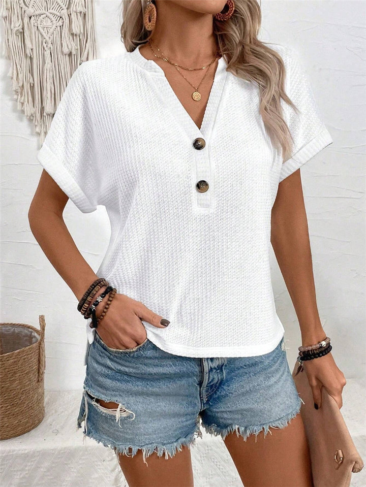 Casual short sleeve t-shirt for women with a decorative button placket design and a chic honeycomb texture