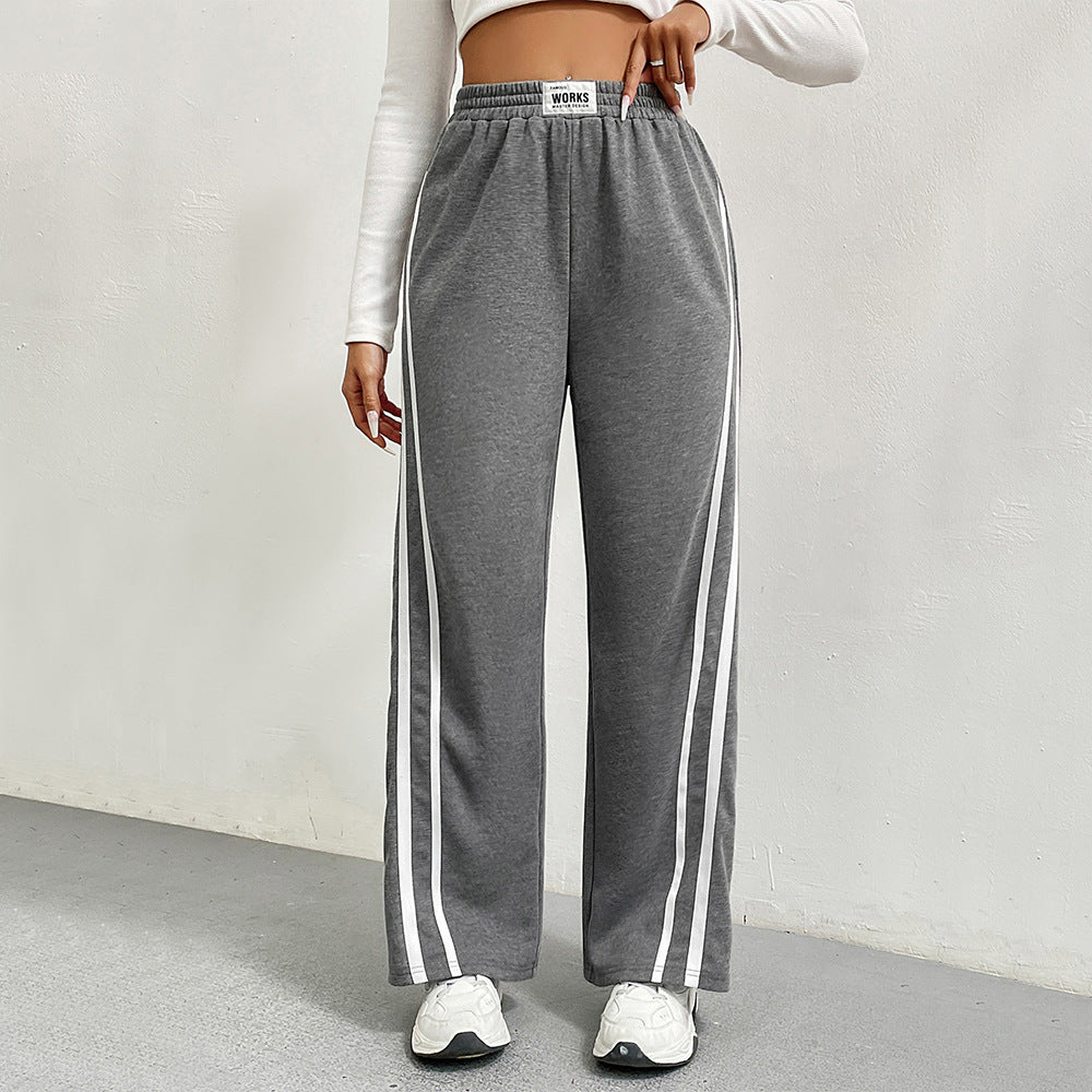 Pantalons de loisirs sportifs pour femmes avec coupe large et rayures contrastées Chic & Stil