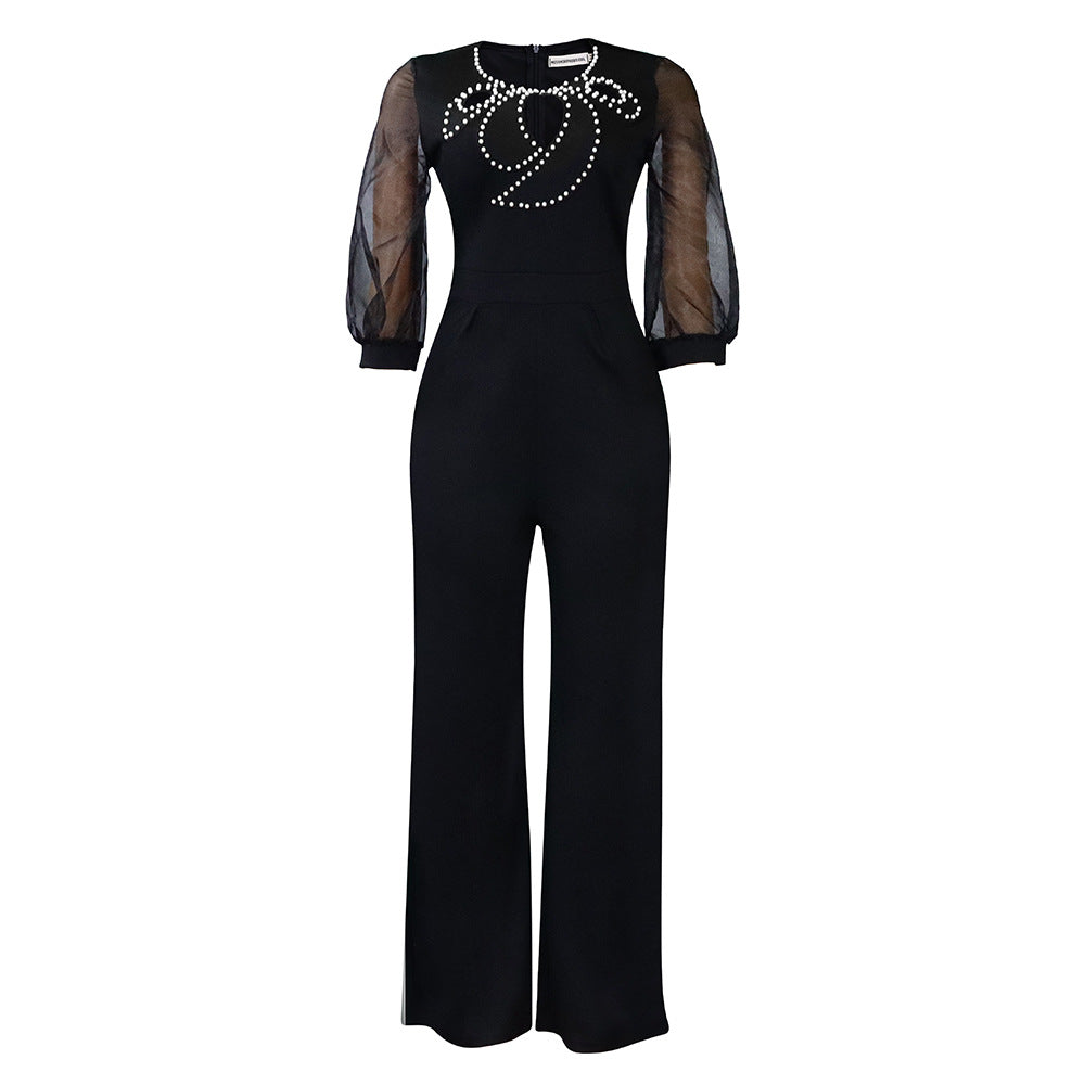 Elegant woman’s jumpsuit with sheer sleeves and pearl embellishment Lune London