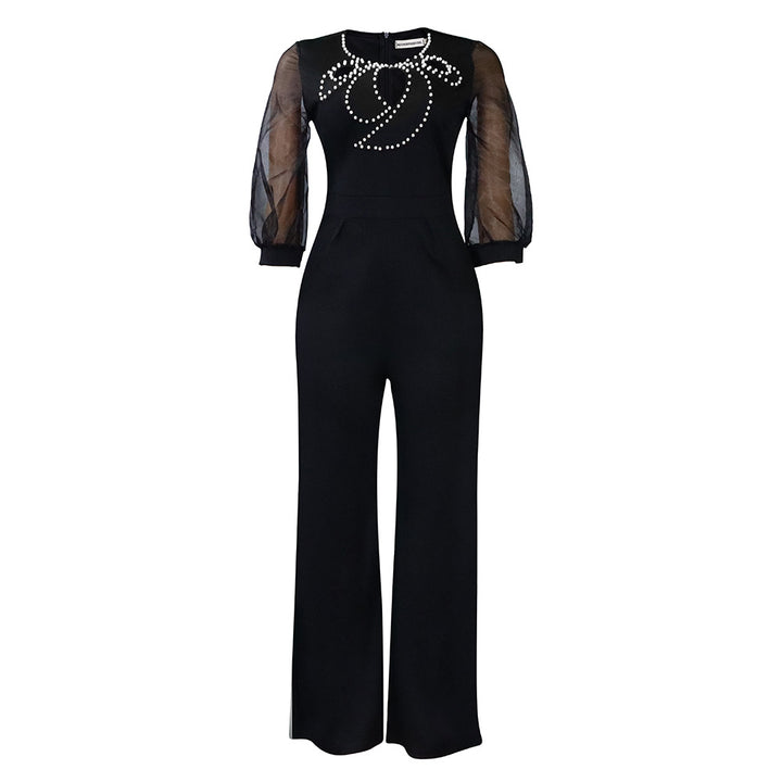 Elegant woman’s jumpsuit with sheer sleeves and pearl embellishment Lune London