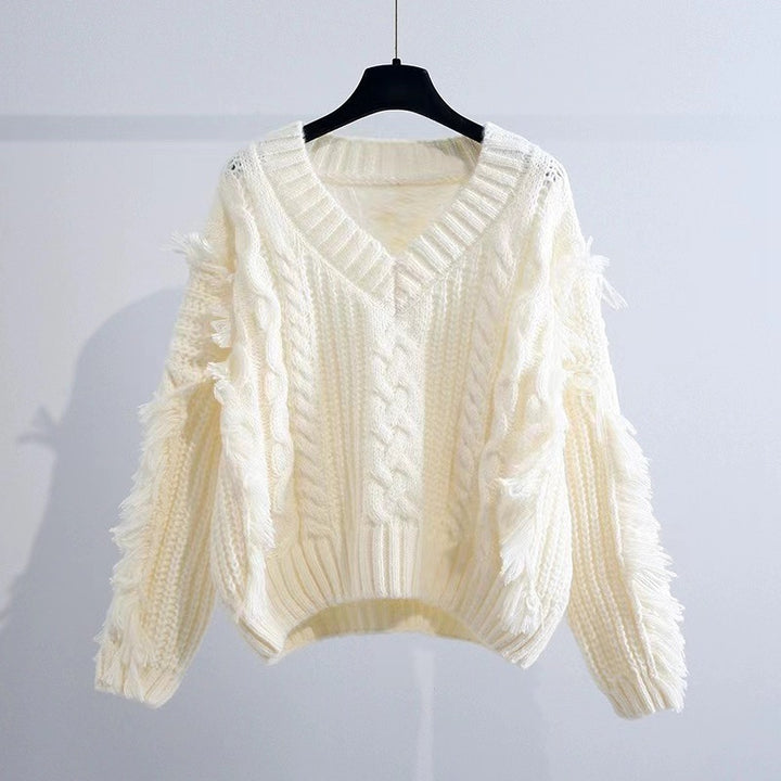 Knit pullover for women with eye-catching fringes and a chic cable knit pattern