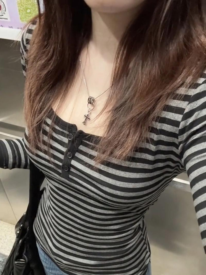 Women's long sleeve shirt with modern striped pattern and decorative button details Chic & Stil