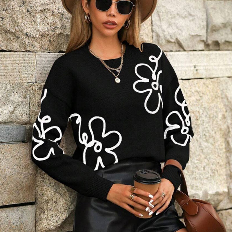Pull féminin à la mode avec des appliqués floraux Chic & Stil