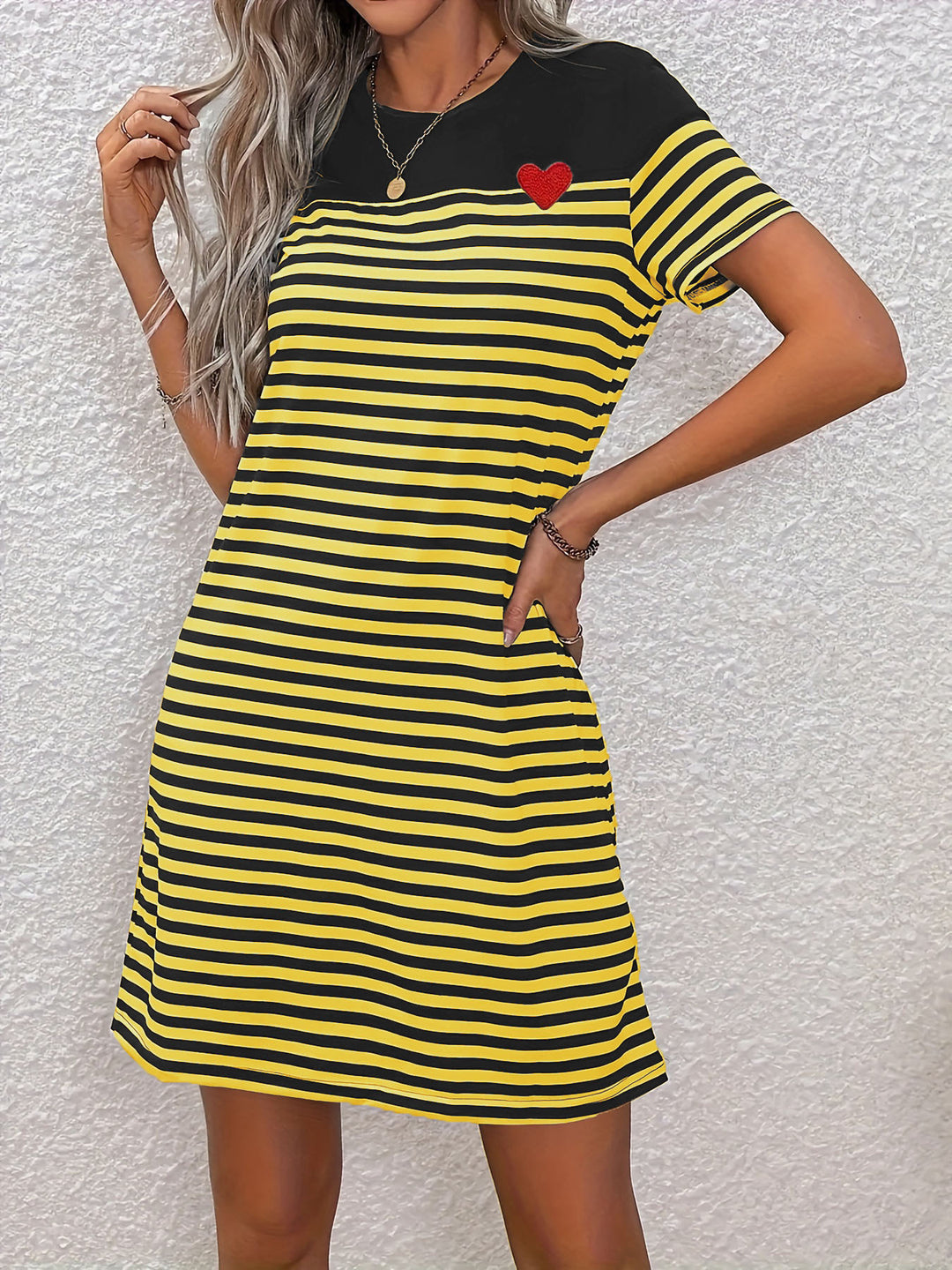 Short sleeve dress for women with colorful striped pattern and heart-shaped detail Lune London