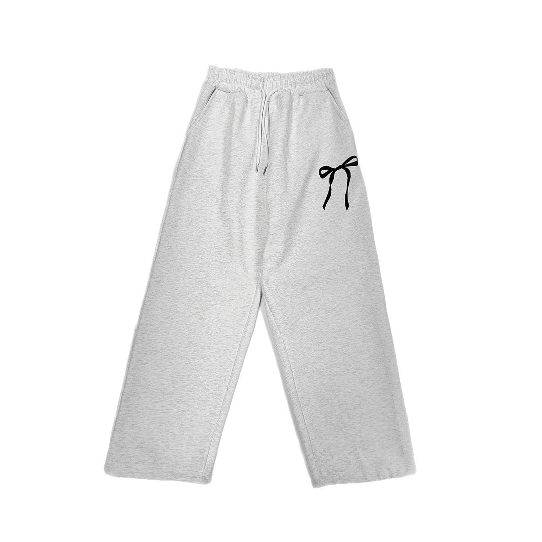 Women's loose leisure pants with elastic waistband and decorative bow motif Chic & Stil
