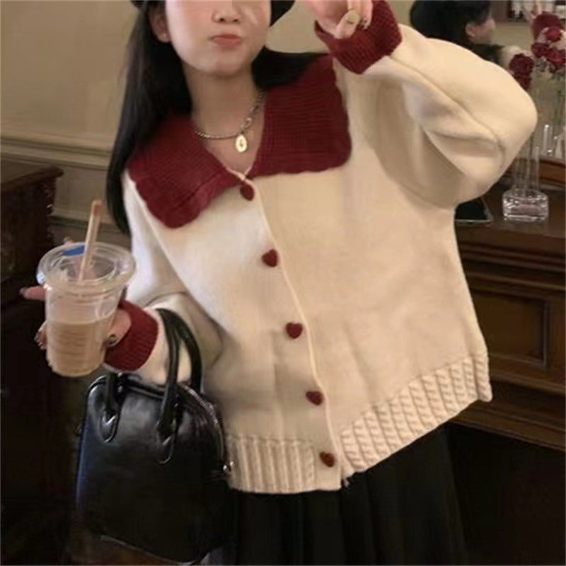 Knitted women's jacket with heart-shaped buttons and a distinctive ruffle collar Lune London