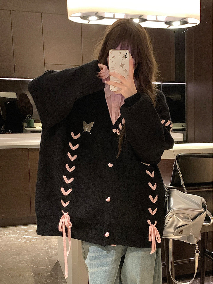 Ladies knit vest with playful heart-shaped details and a chic bow