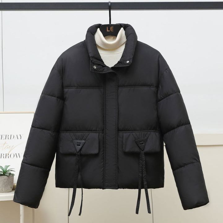 Quilted transitional jacket for women with high collar and practical modern pockets Lune London