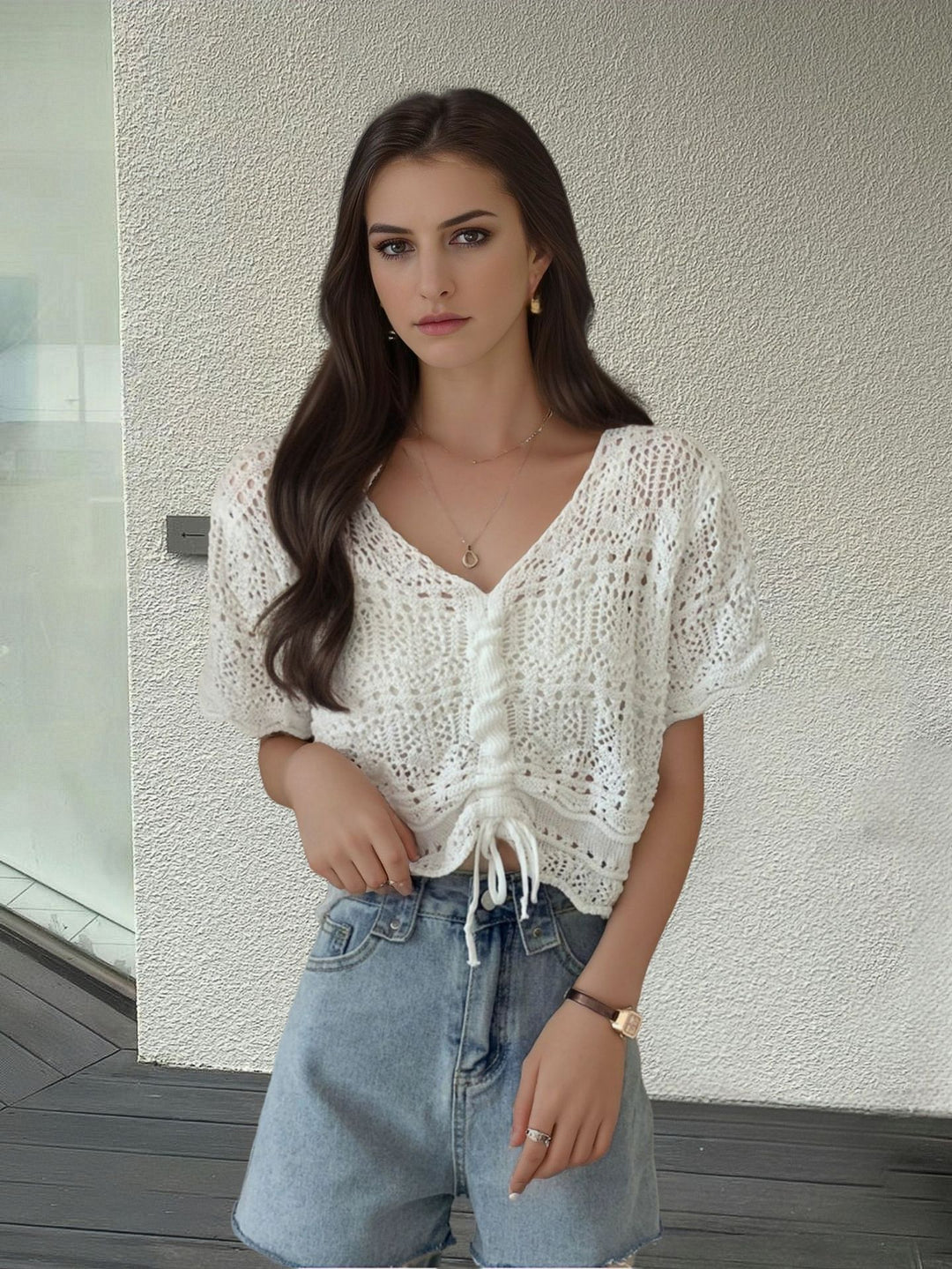 Women's knit top with decorative hole pattern and adjustable hem Lune London
