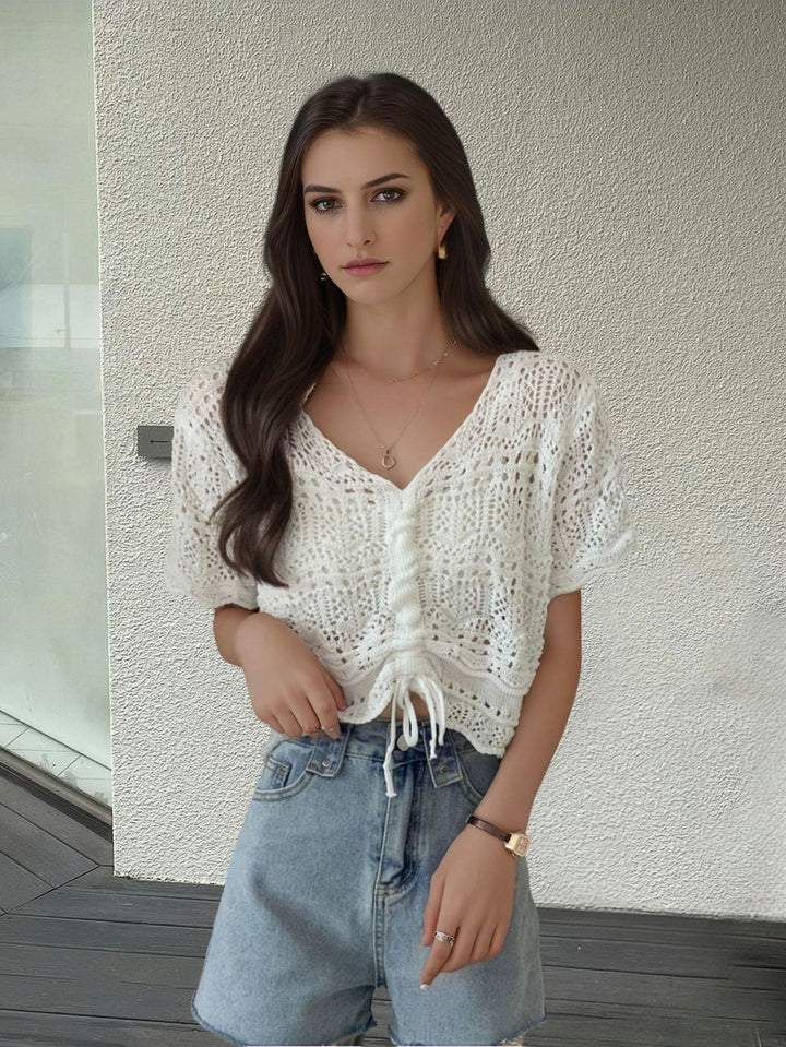 Women's knit top with decorative hole pattern and adjustable hem Lune London