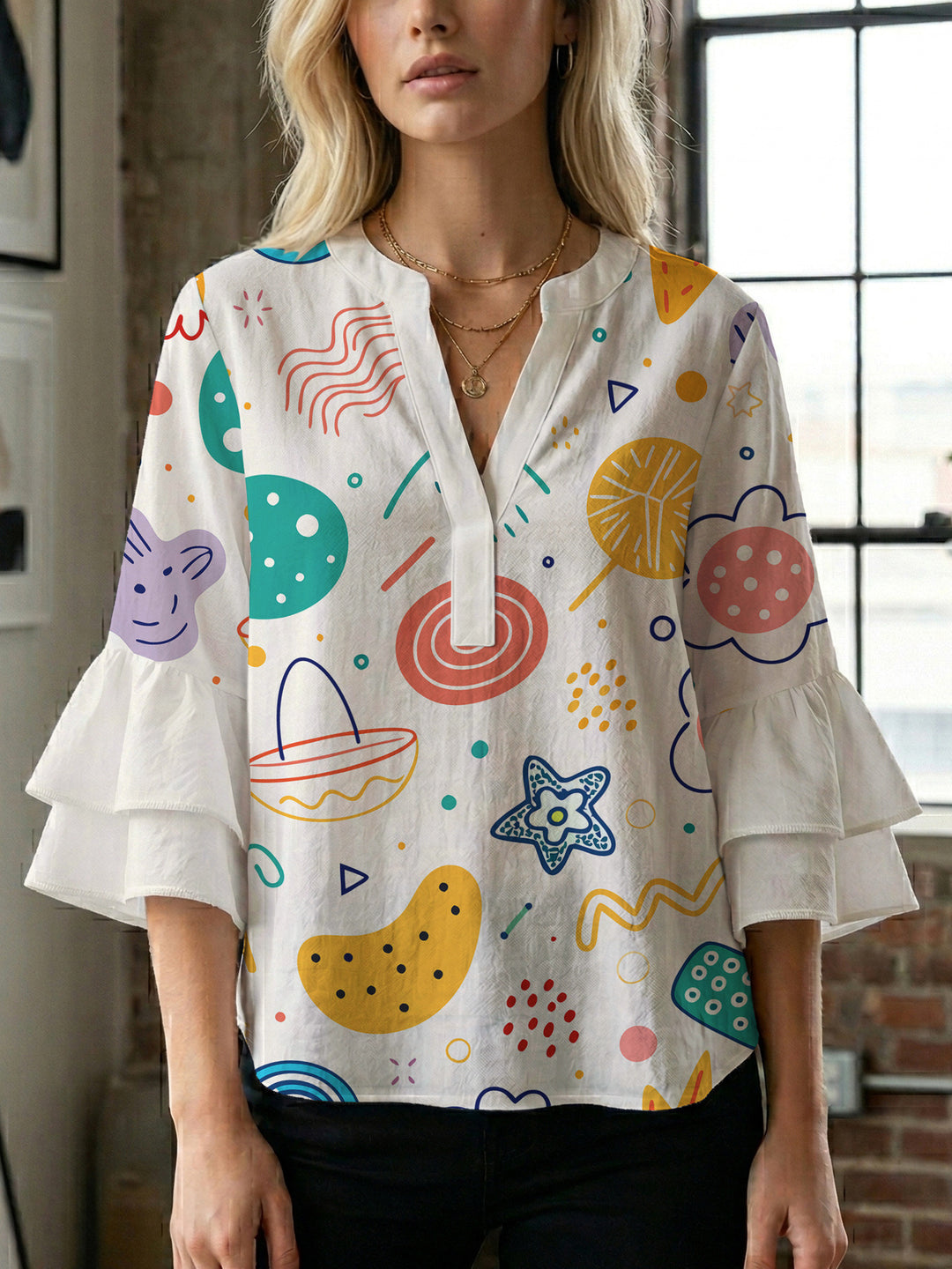 Women’s blouse with voluminous ruffled sleeves and floral pattern Lune London