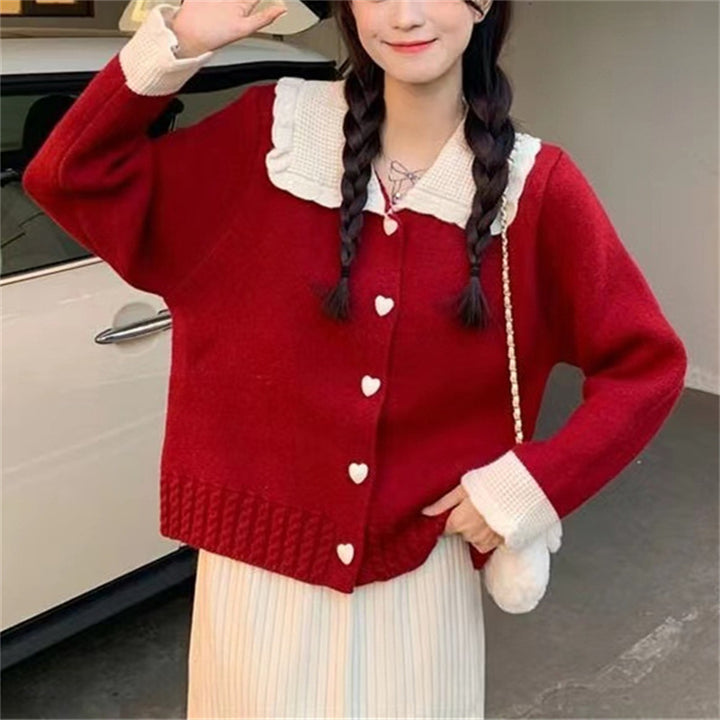 Knitted women's jacket with heart-shaped buttons and a distinctive ruffle collar Lune London