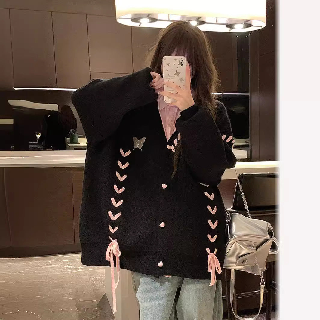 Ladies knit vest with playful heart-shaped details and a chic bow