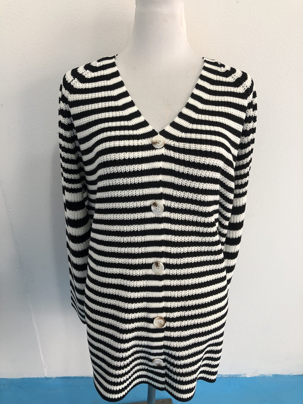 Ladies long sleeve knit cardigan with a modern striped pattern and buttons Lune London