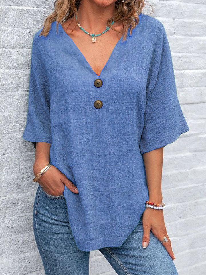Ladies' V-neck blouse with decorative buttons and chic casual cut
