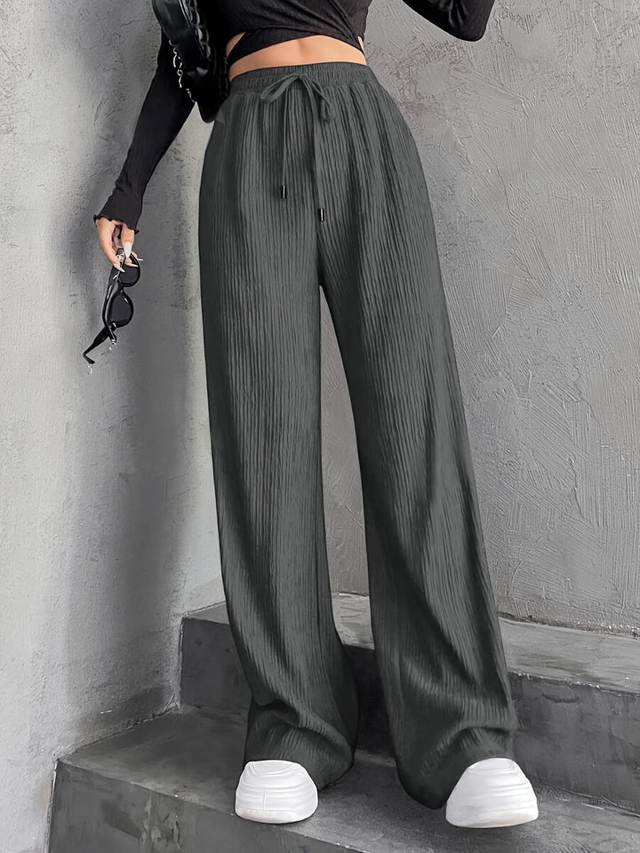 Pantalons plissés à coupe large pour femmes avec taille élastique et poches latérales pratiques Chic & Stil