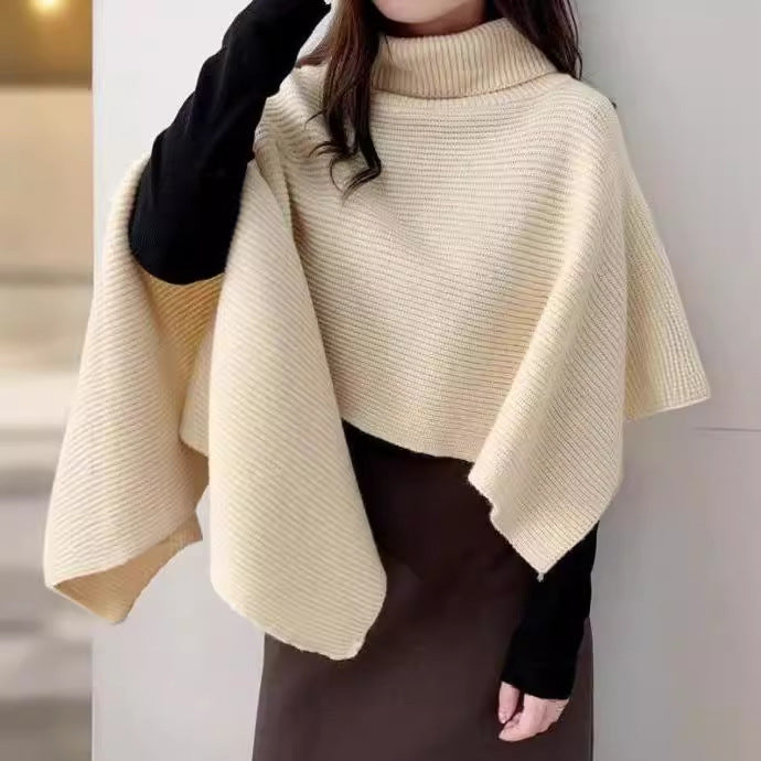 Ladies knitted poncho with high collar and asymmetrical cut Lune London