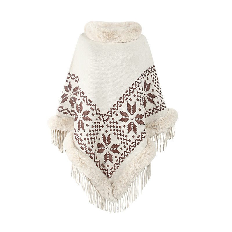 Elegant women's poncho with decorative fringe design and faux fur trim Lune London