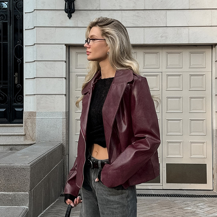 Synthetic leather biker jacket for women with a slim fit and chic metal zippers.