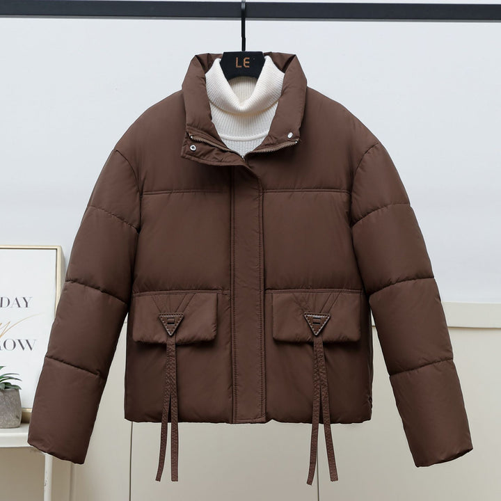 Quilted transitional jacket for women with high collar and practical modern pockets Lune London