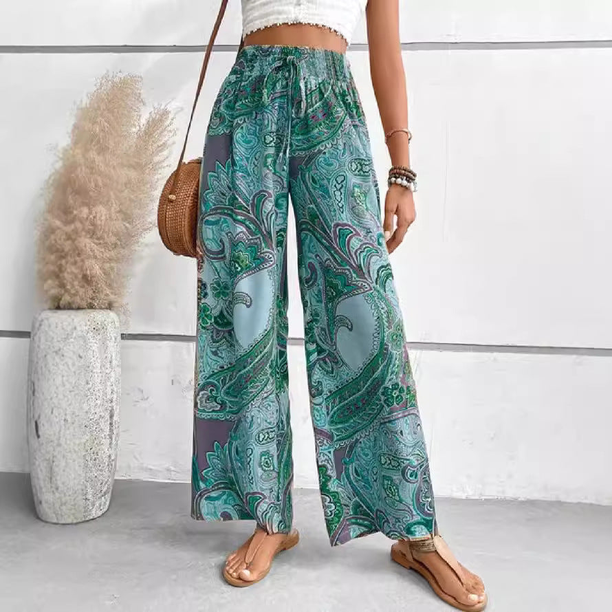 Wide palazzo pants for women with a colorful paisley pattern and an elastic waistband Lune London