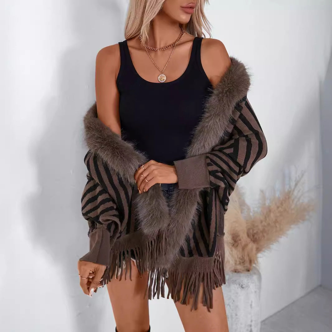 Ladies knitted poncho with elegant faux fur collar and fringe design Lune London