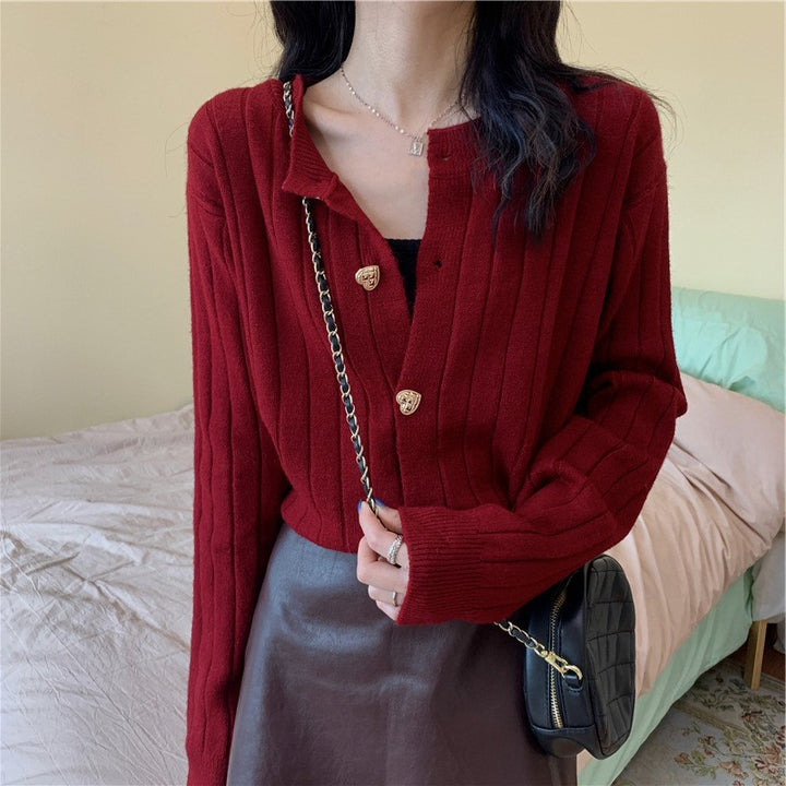 Women's knit jacket with a decorative button design and a vertical ribbed pattern Lune London