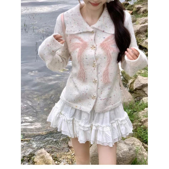 Women’s playful knitted vest with decorative button details and fluffy applications Lune London