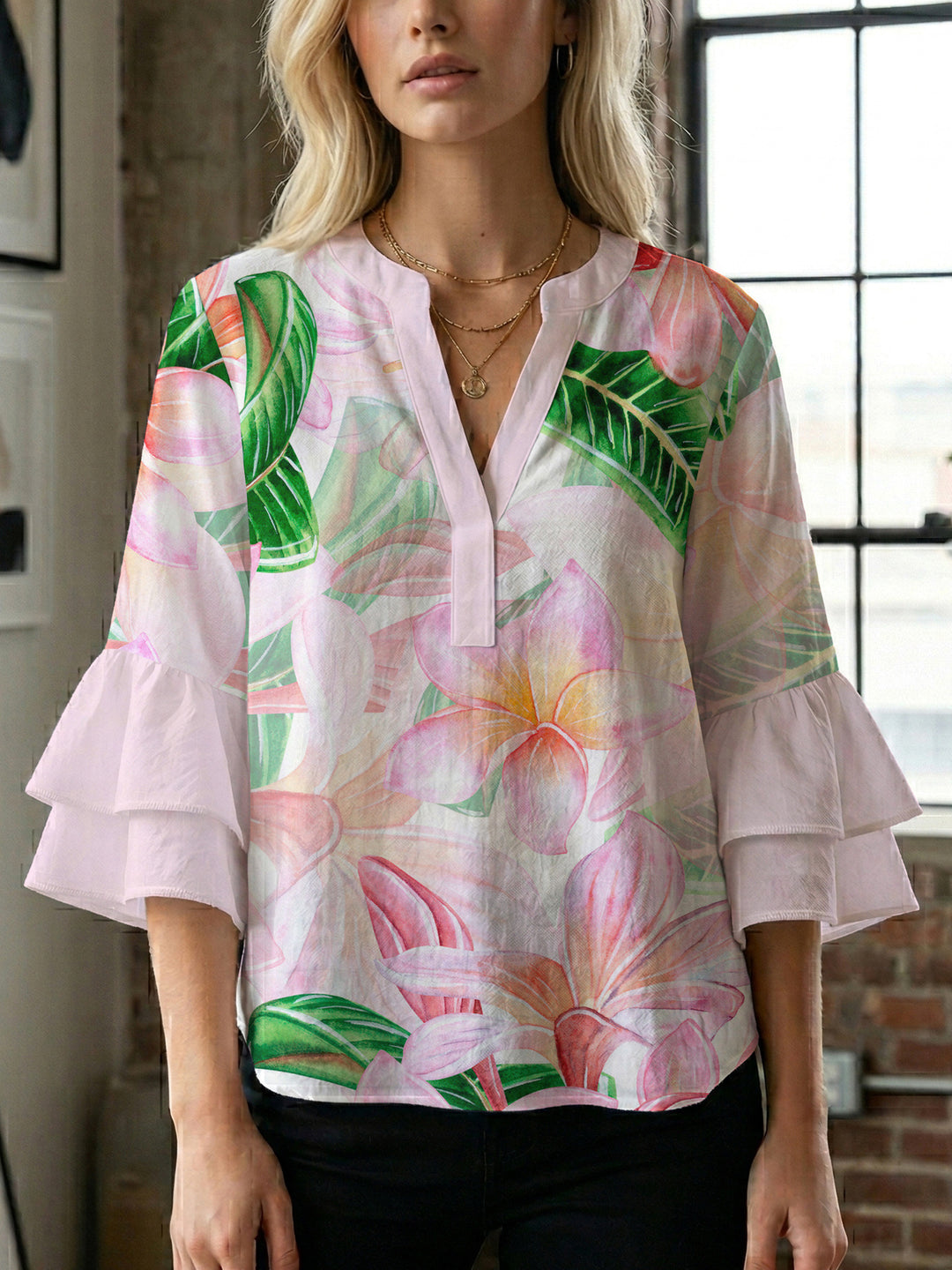 Women’s blouse with voluminous ruffled sleeves and floral pattern Lune London