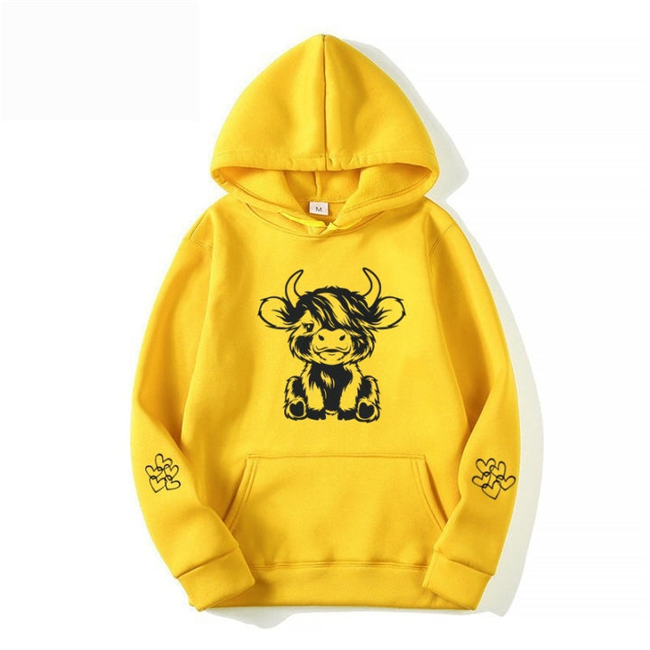 Women's hooded sweatshirt with charming cow motif and practical kangaroo pockets Lune London