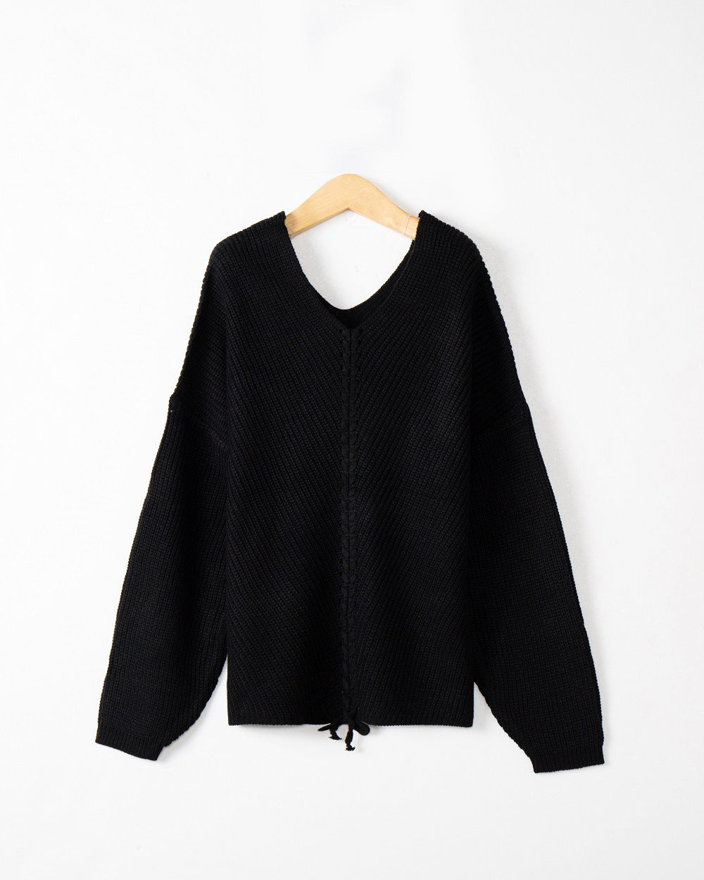 Women's thick knit sweater with an attractive V-neckline and practical drawstring details Lune London