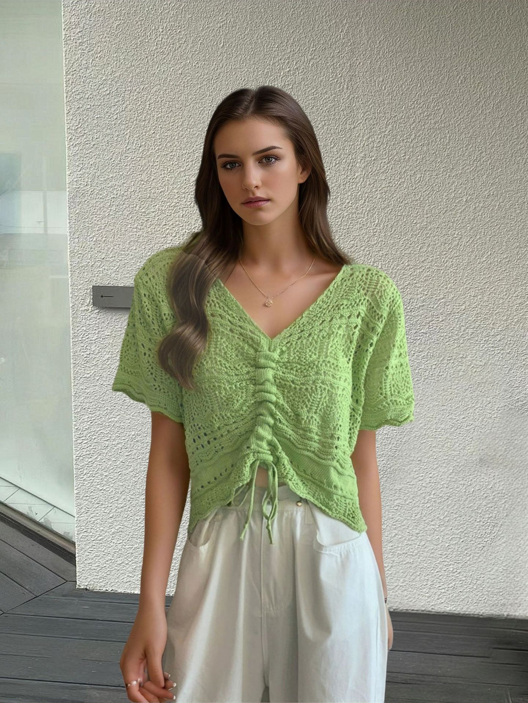 Women's knit top with decorative hole pattern and adjustable hem Lune London