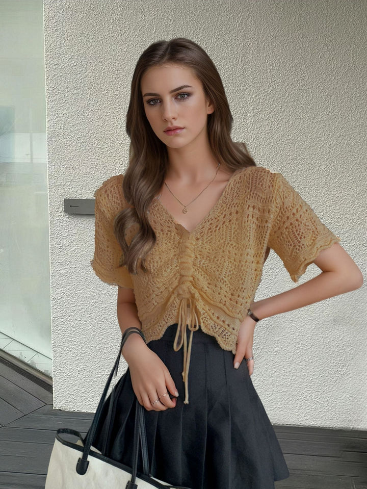 Women's knit top with decorative hole pattern and adjustable hem Lune London