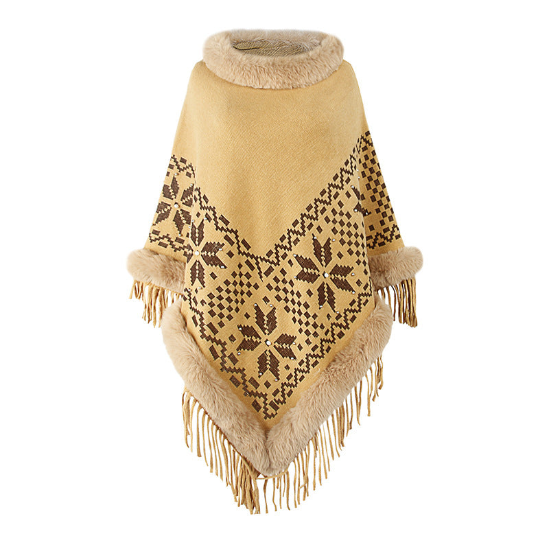 Elegant women's poncho with decorative fringe design and faux fur trim Lune London